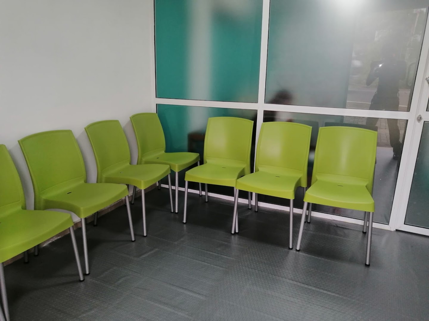 Lime green seating beside frosted glass panels